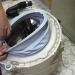 Lining up the drain holes on the seal with the bottom of the drum